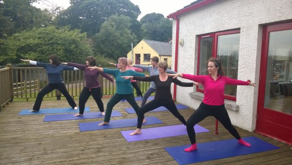 Blaney Spa and Yoga Centre outside decking with people practicing yoga poses