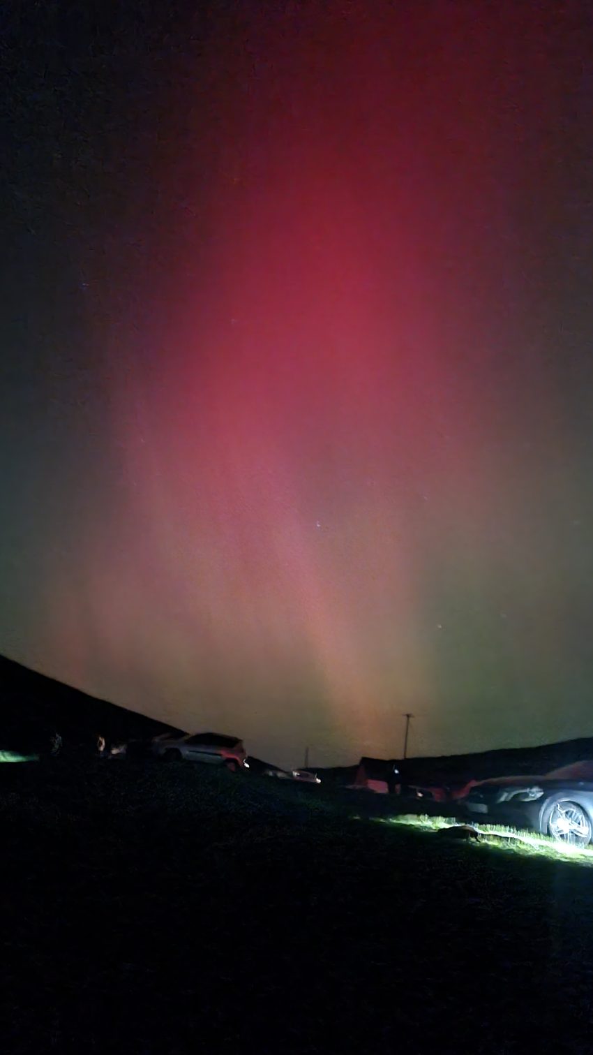 View of red and green Northern Lights in the Sky, at Spelga Dam Co Down NI