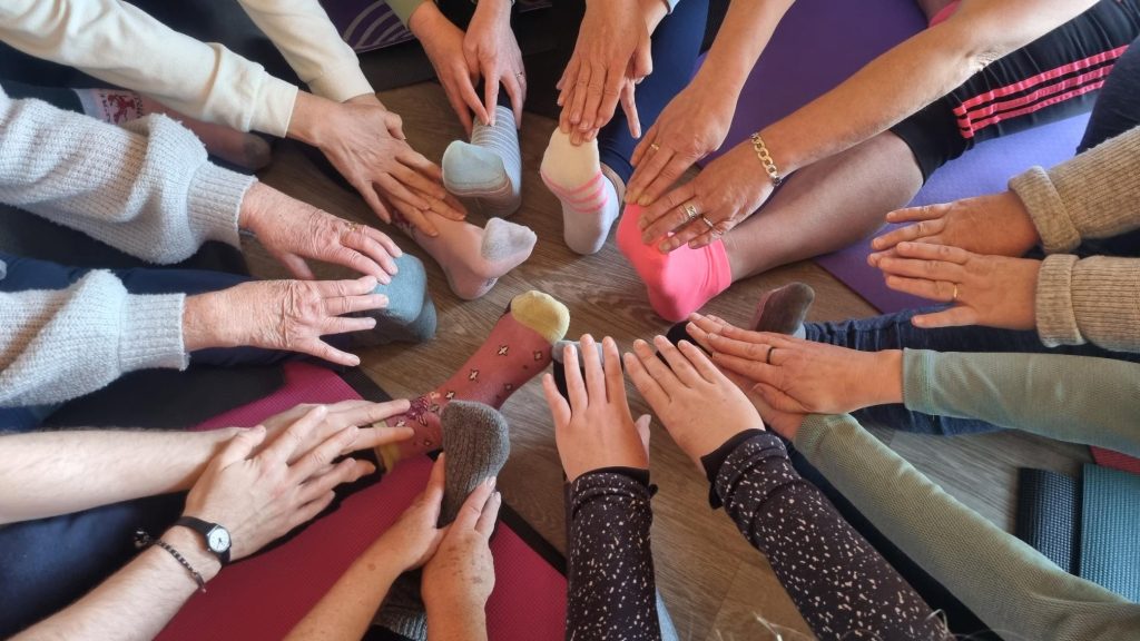 yoga workshop with many hands